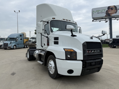Mack AN42T conventional daycab tractor in white, front-left view with large grille and Mack logo, fuel tanks, and side steps visible.