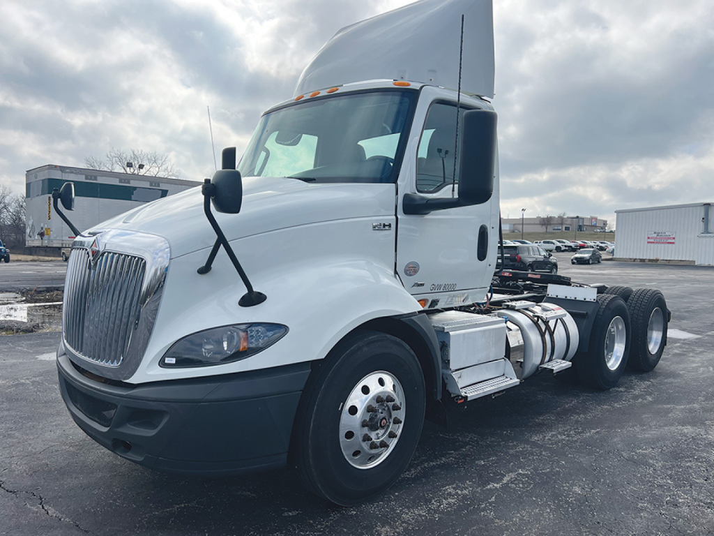 Front-left view of a white 2019 International RH613 daycab truck with a raised roof, showing front grille, headlights, and side fuel tanks.