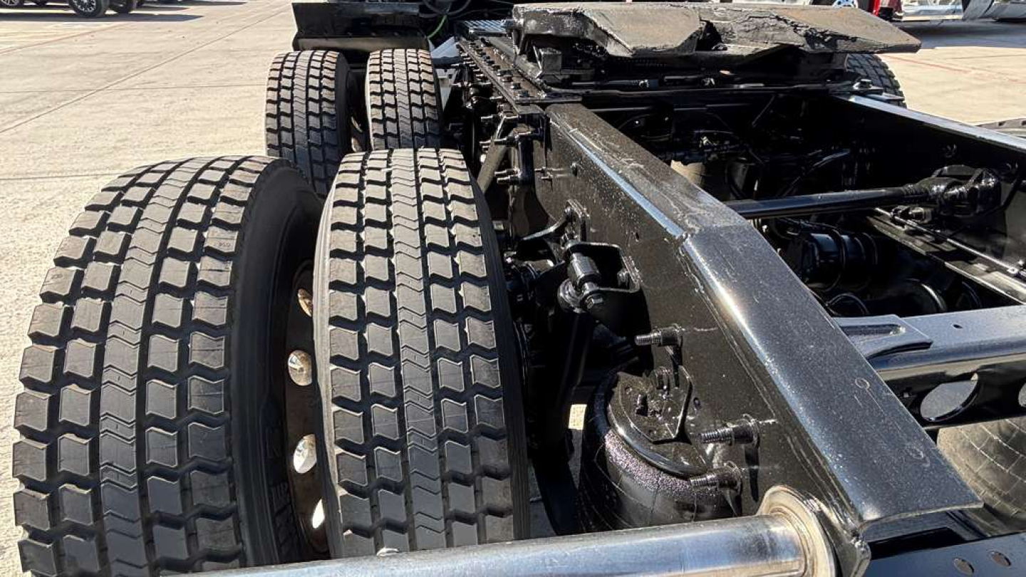 Truck chassis and dual rear axles with heavy-duty tires and frame showing undercarriage of a 2022 International LT625 conventional sleeper.