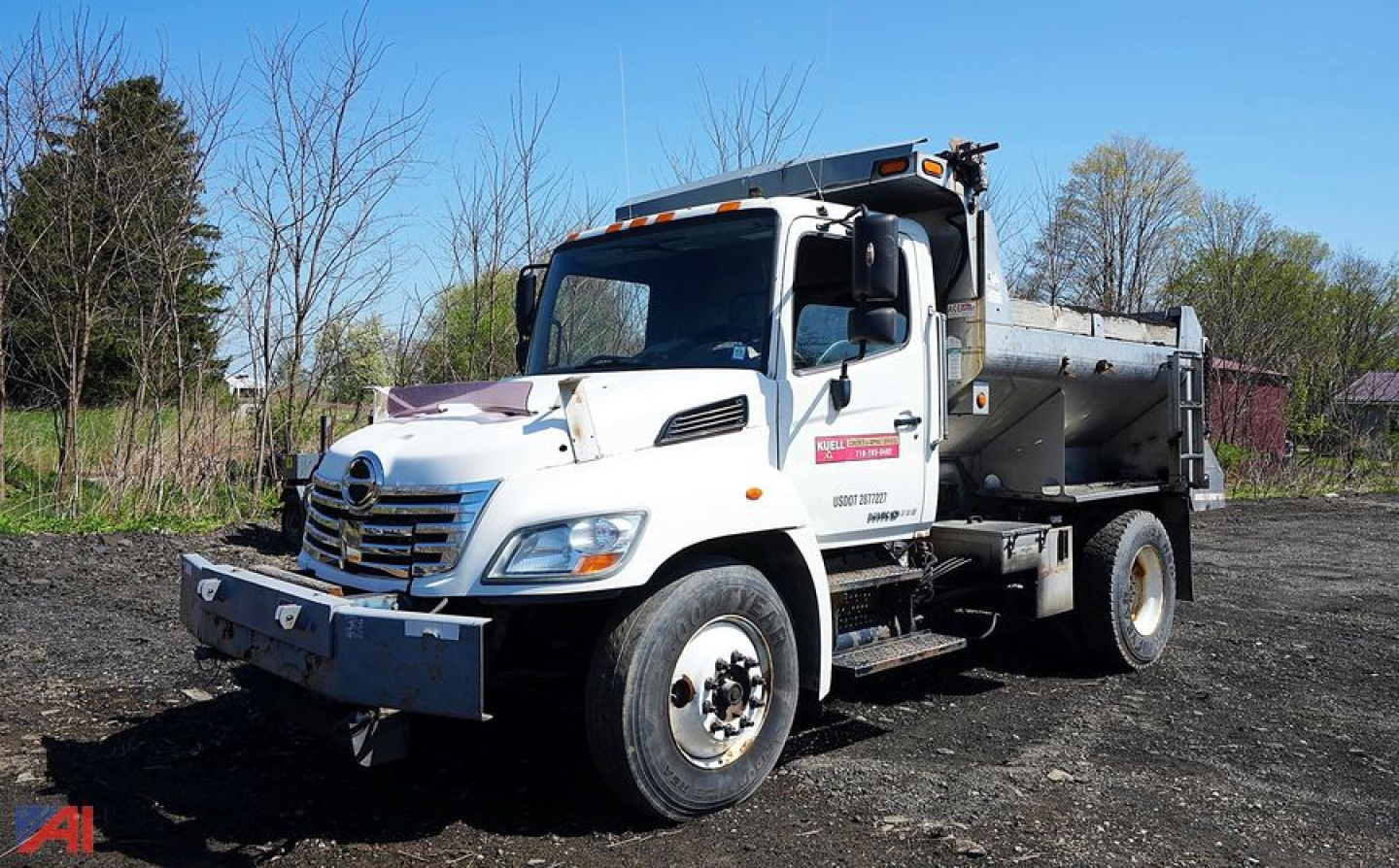 Dump truck showing 2010 Hino 338 4x2 all-season dump body with front bumper and dual rear wheels.