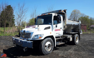 Dump truck showing 2010 Hino 338 4x2 all-season dump body with front bumper and dual rear wheels.