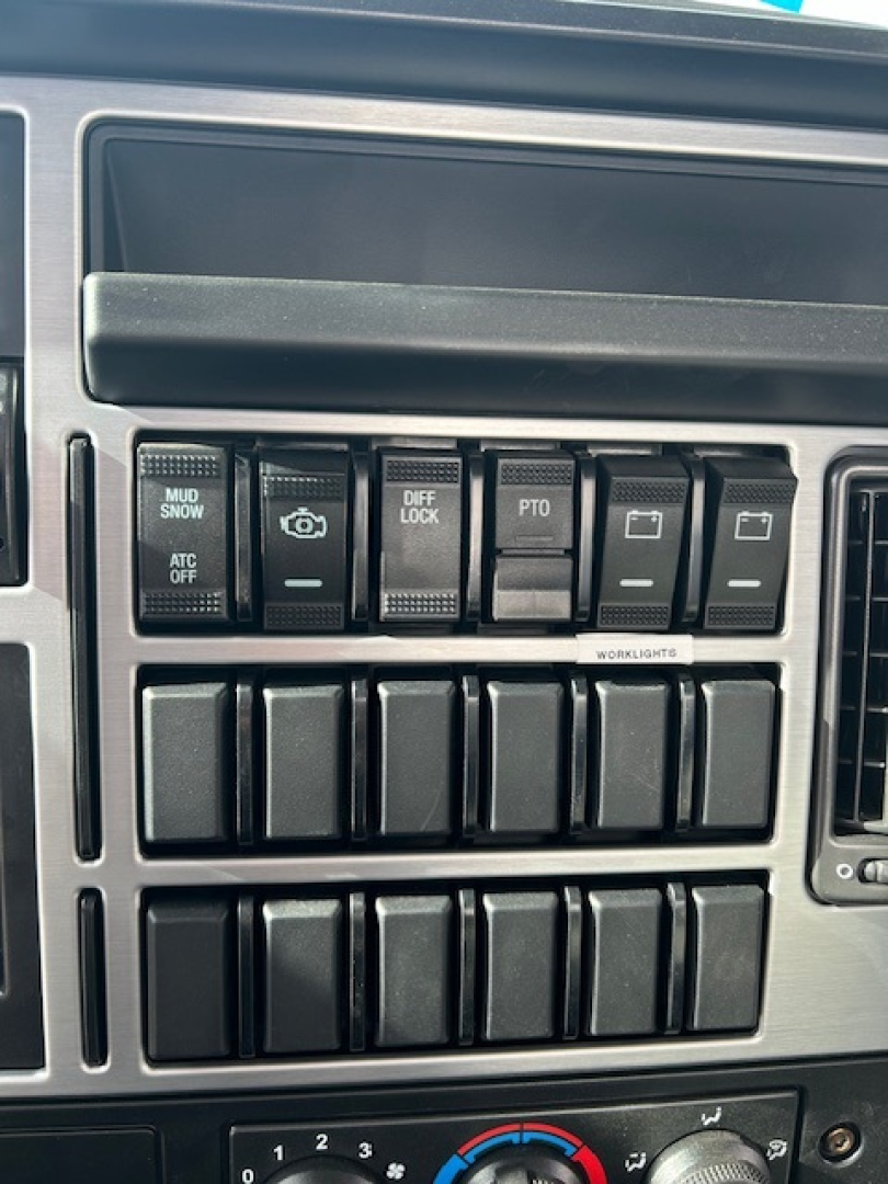MD7 dash cluster showing multiple switch panels including ATC OFF, DIFF LOCK, PTO, MUD/ SNOW, and work lights switches.