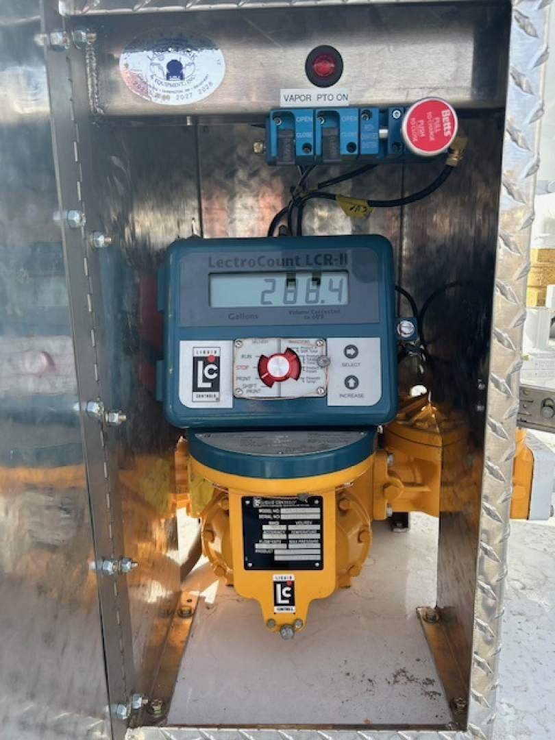 Measuring device mounted inside a metal cabinet showing a LecroCount LCR-i meter reading 28.6 with a yellow device below and blue wiring terminal blocks above.