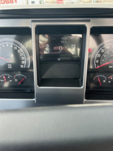 Dashboard of a Mack MD7 truck showing digital gauge cluster with gear indicator N, speed 0, and various instrument dials.