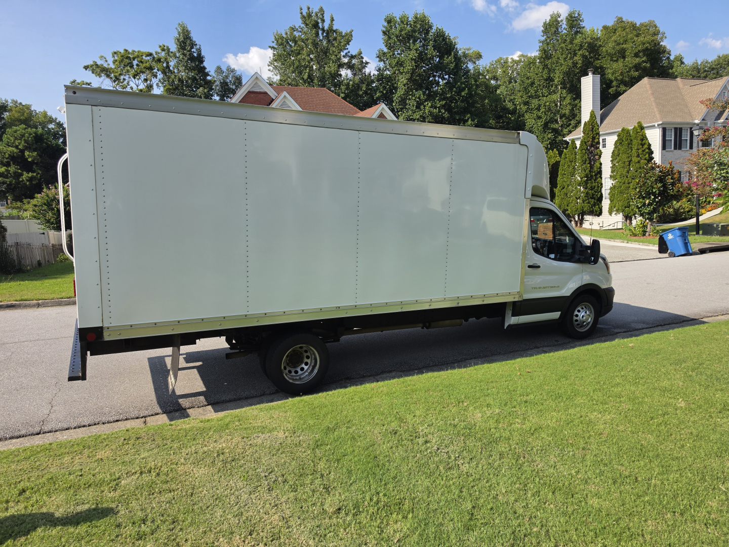 Box truck side view showing white cargo box mounted on a light commercial van chassis, no visible text on side.