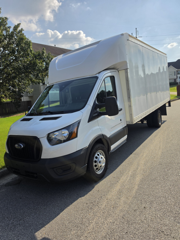 Box truck with a white cab and large box cargo area, Ford Transit 350 HD, VIN visible.