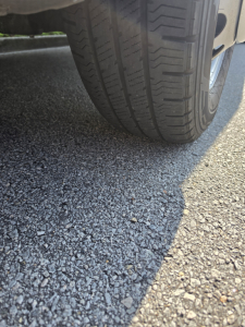 Wheel and ground view of a Ford Transit 350 HD showing tire tread and pavement.