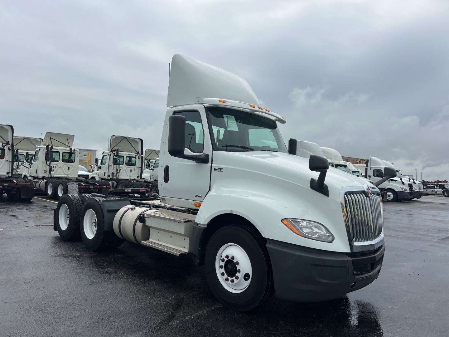Truck: 2019 International LT daycab tractor in white, front right view, with large grille and dual rear axles.