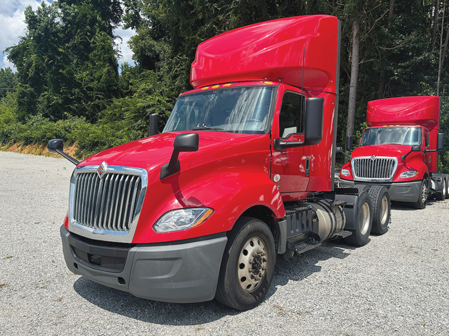 Truck cab and sleeper in-service International LT625 daycab with red exterior showing front grille, headlights, and dual rear axles.