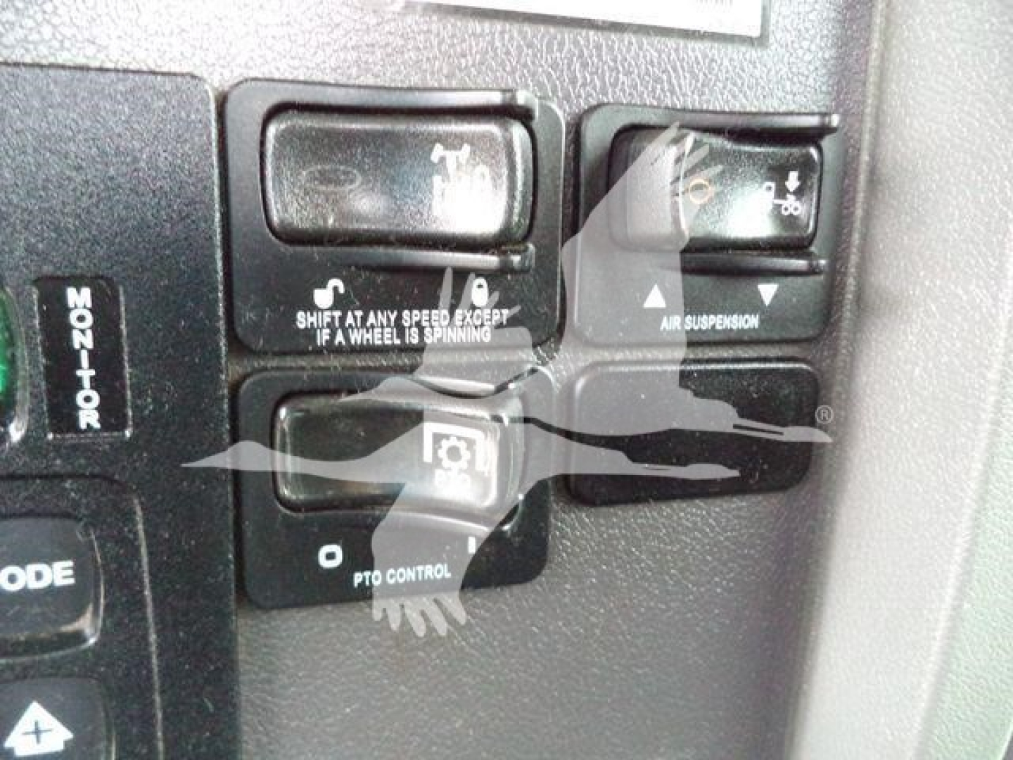 Peterbilt 348 truck dashboard controls showing shift/aux controls and air suspension indicator.