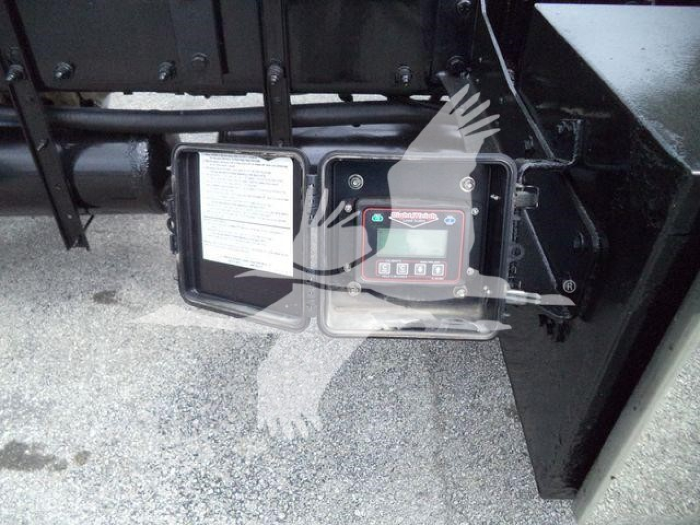 Peterbilt 348 rollback truck engine bay area with control panel and label plate visible.