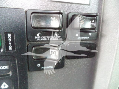 Peterbilt 348 truck dashboard controls showing shift/aux controls and air suspension indicator.