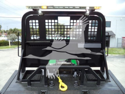 Peterbilt 348 rollback truck bed with cage and hitch, rear view showing towing eye and tool boxes.