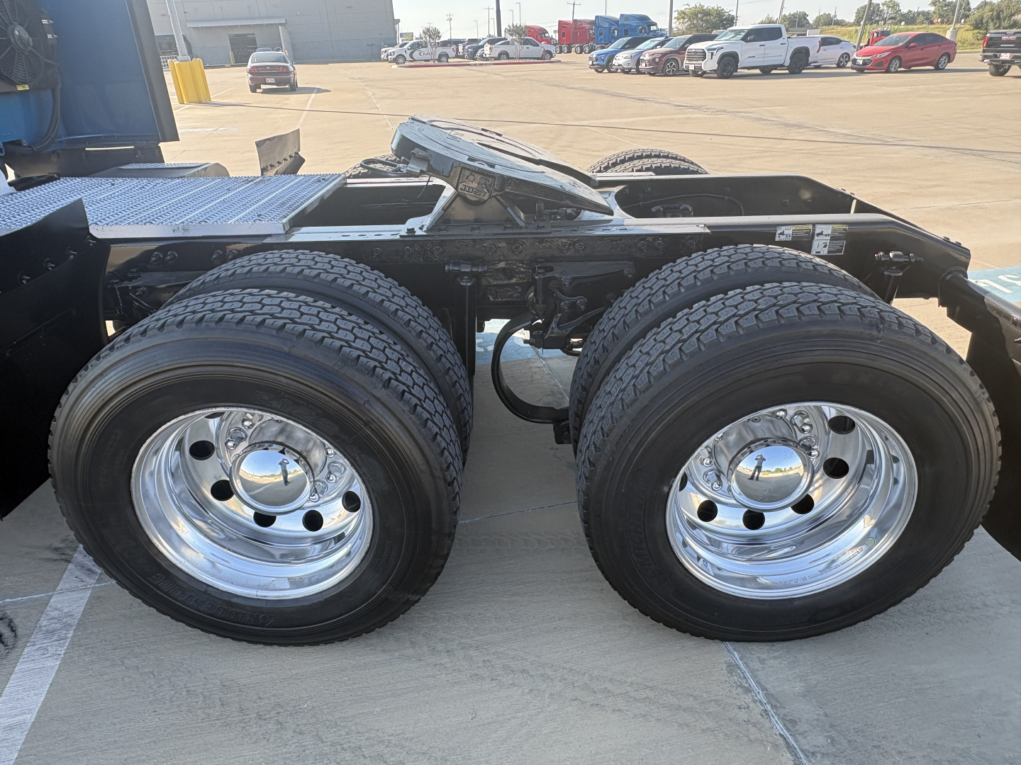 Peterbilt 579 truck rear dual-axle configuration with chrome wheels and dual tires, trailer hitch area visible.