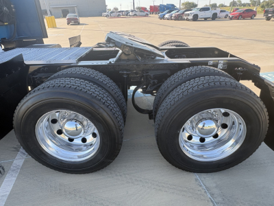 Peterbilt 579 truck rear dual-axle configuration with chrome wheels and dual tires, trailer hitch area visible.
