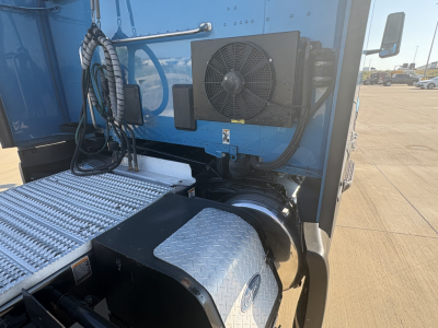 Peterbilt 579 truck side view showing exterior air conditioning/condenser unit and diamond plate step with cab area