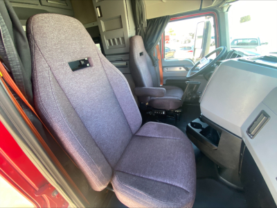 Truck cab interior showing seats and steering wheel of a 2020 Mack AN64T70 conventional sleeper.