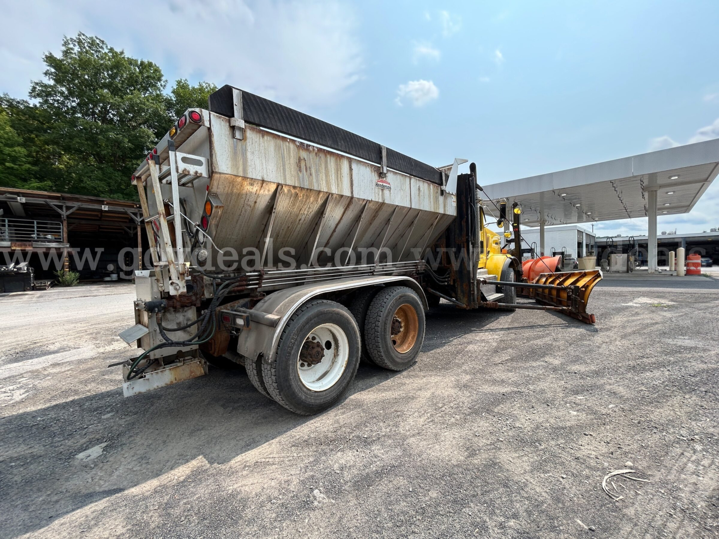 Kenworth T800 dump truck with plow attachment in-service showing rear and side view