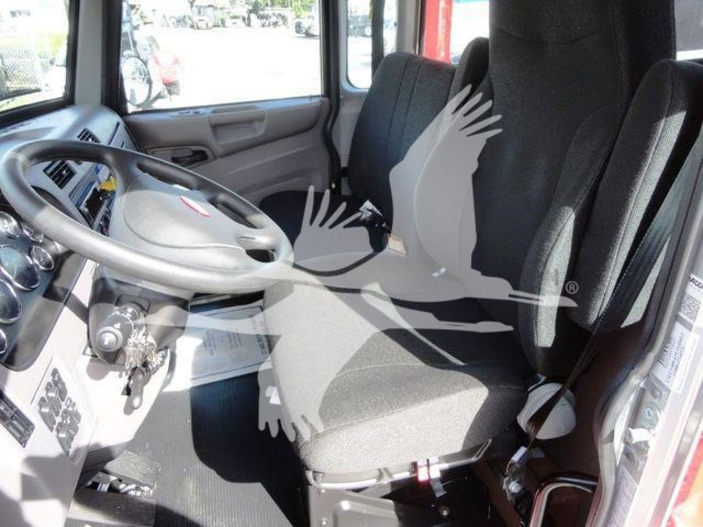 Peterbilt 337 cab interior showing steering wheel, driver seat, and instrument cluster.