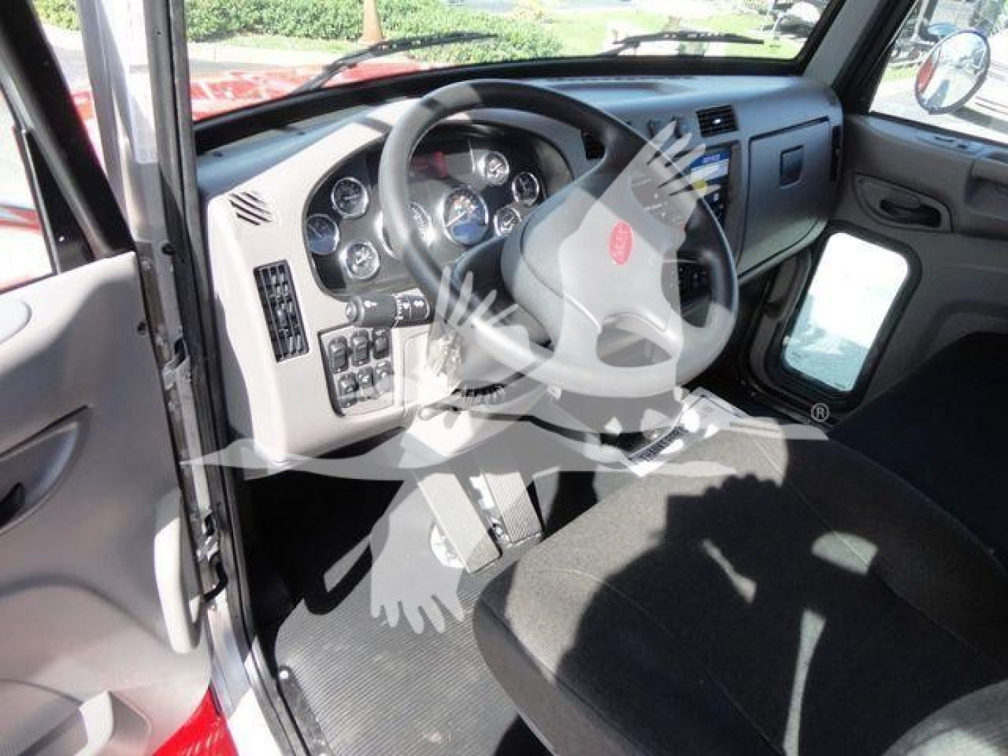 Peterbilt 337 cab interior showing steering wheel and dashboard with controls and gauges.