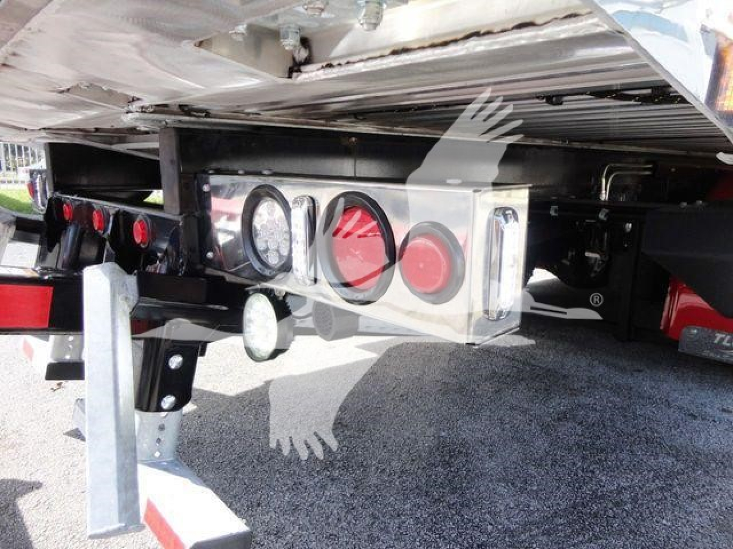 Peterbilt 337 rollback with rear bumper lights and hitch assembly. Visible text includes circular taillights and reflective panels; no legible serials or model text.
