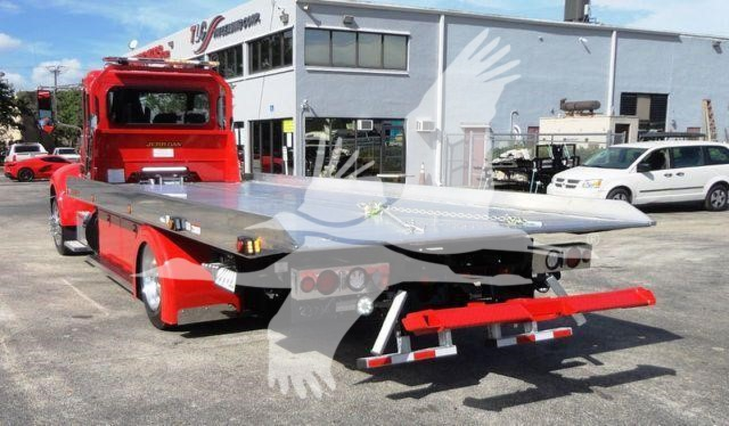 Peterbilt 337 rollback truck with flatbed in-service winch area and rear view showing hydraulic ramps.