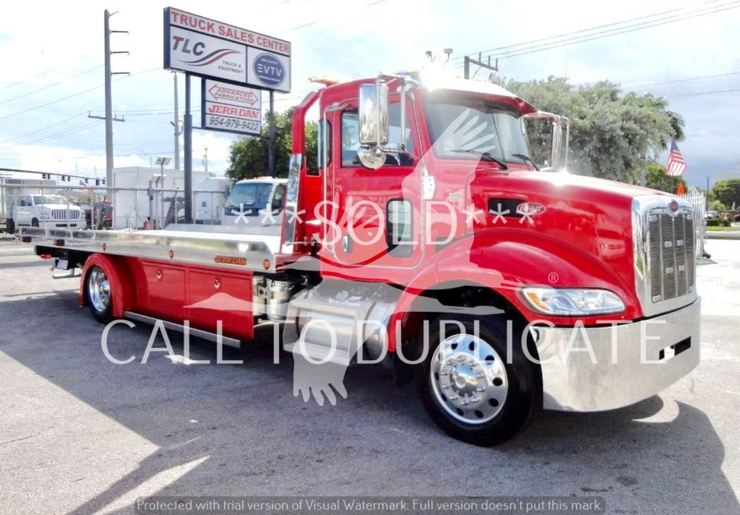 Peterbilt 337 tow truck side view showing bright red rollback chassis with chrome bumper and wheels, VIN plate not visible.
