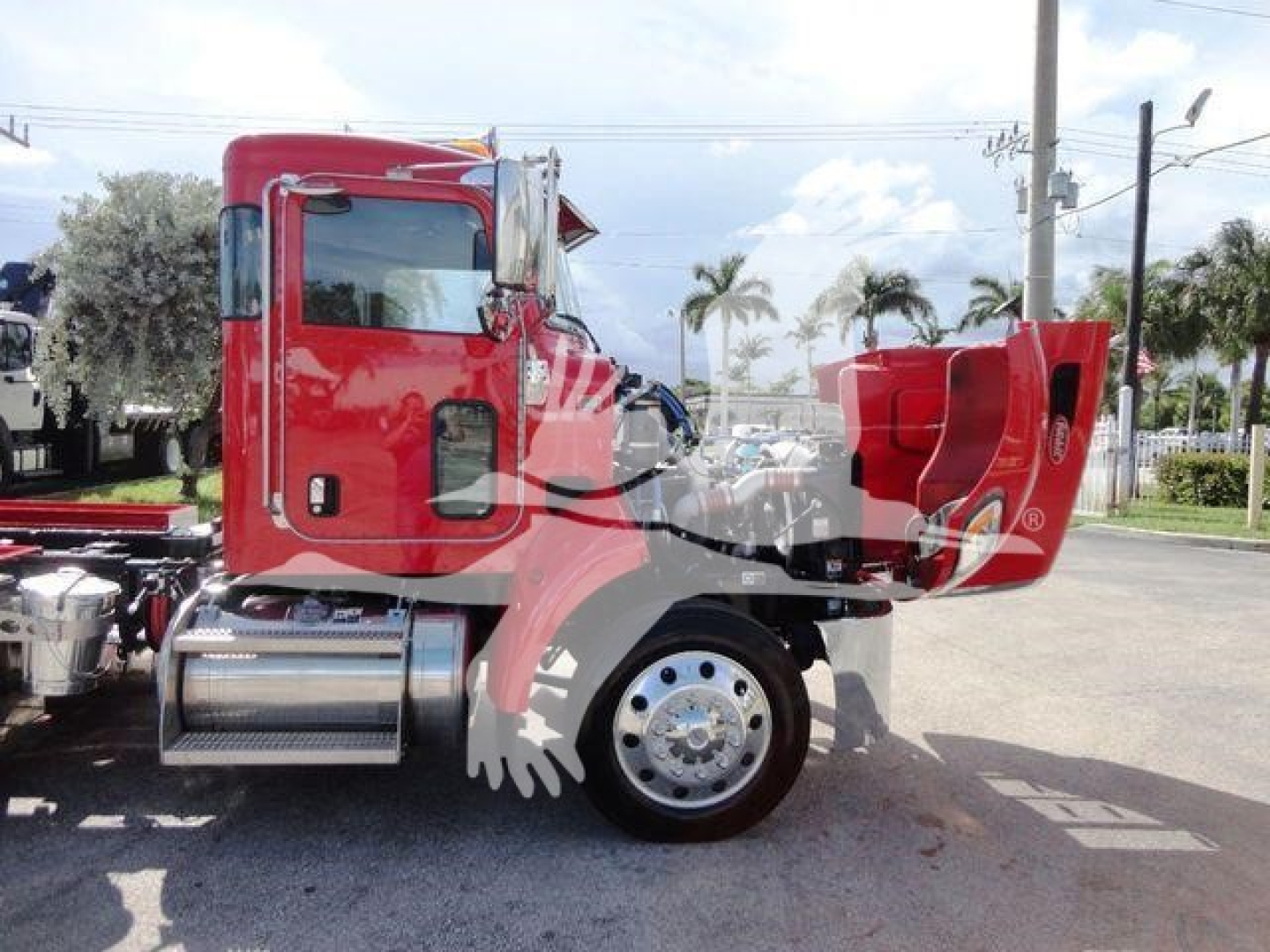 Peterbilt 337 truck side view showing cab, rear hood open, front wheel, chrome fuel tank, red paint, stock number J61992.