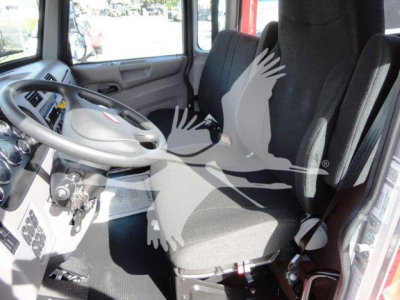 Peterbilt 337 cab interior showing steering wheel, driver seat, and instrument cluster.