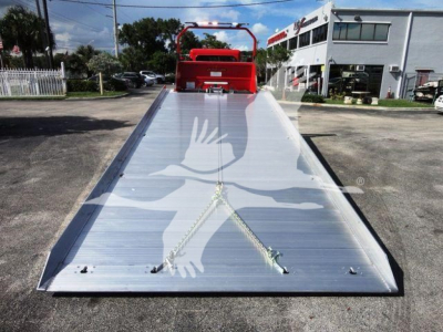 Peterbilt 337 rollback bed with aluminum tilting ramp and hydraulic mechanism, front view showing platform in the open position.
