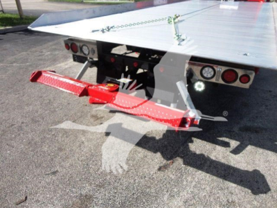 Peterbilt rollback truck bed rear with red towing arm and warning lights.