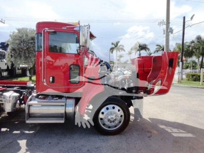 Peterbilt 337 truck side view showing cab, rear hood open, front wheel, chrome fuel tank, red paint, stock number J61992.