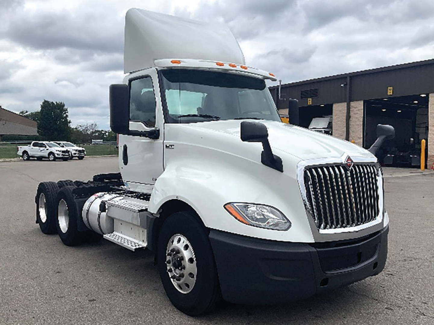International LT Series tractor-trailer cab showing front grille and chassis with dual rear axles; no visible text on the image aside from the truck design.