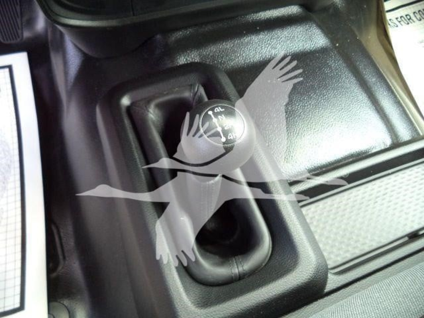 Ram 5500 gear shift area showing 4L 4L? and knob with embossed markings, vehicle interior.