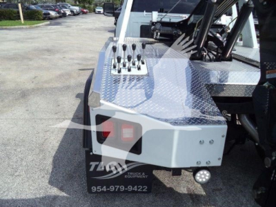 Ram 5500 winch truck rear shows control levers and diamond plate toolbox with TIDOC Truck & Equipment logo and phone number 954-979-9422.