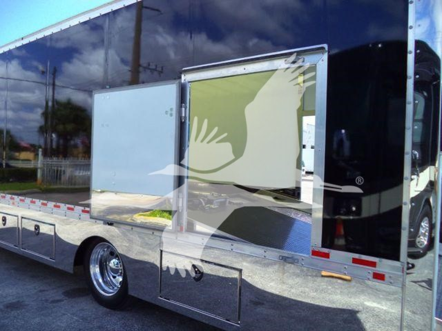 2026 Mack MD6 rollback truck side with open side compartments and reflective chrome panels