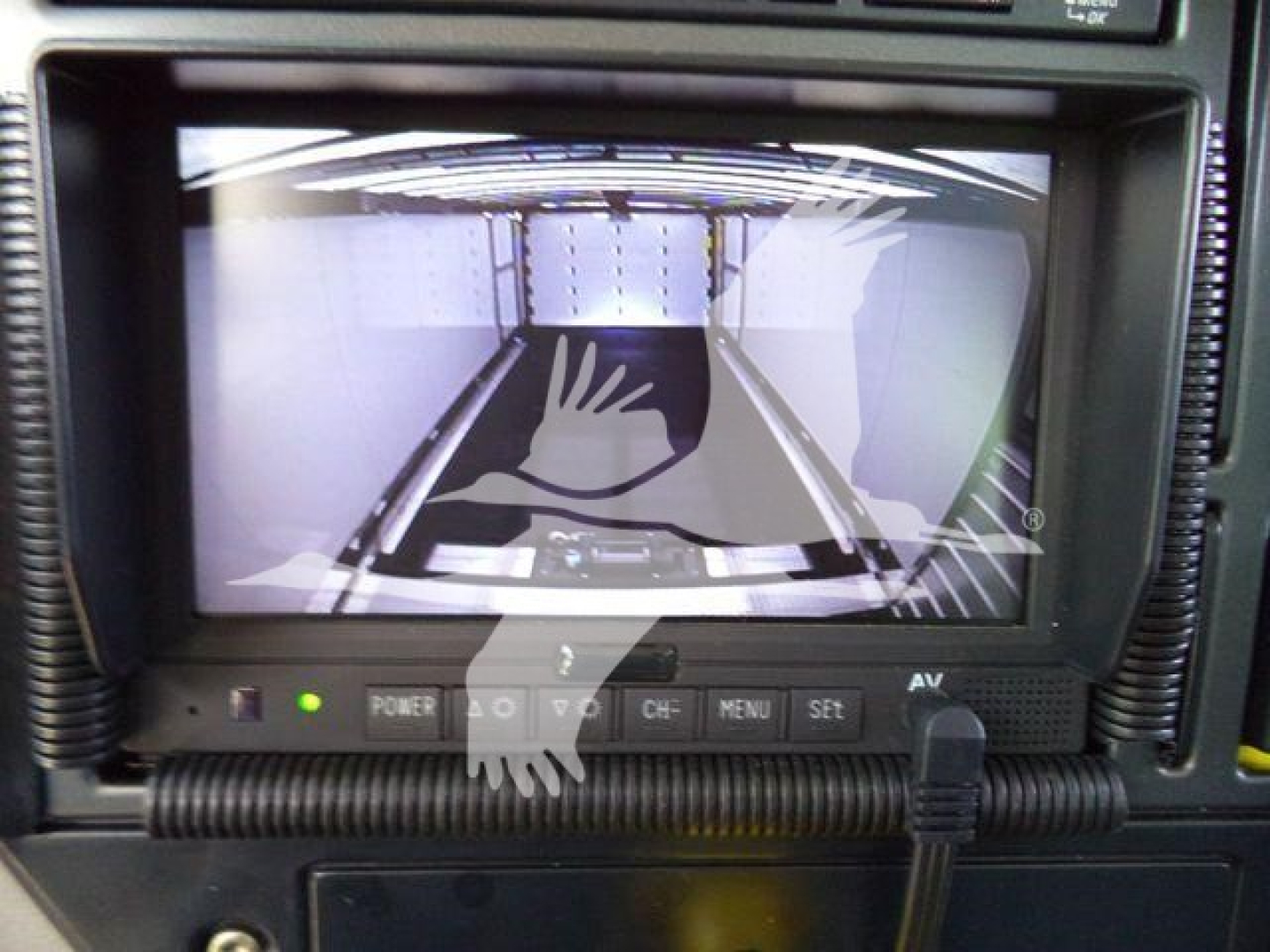 MD6 Mack truck dash display showing rearview camera screen with controls and wiring harness.