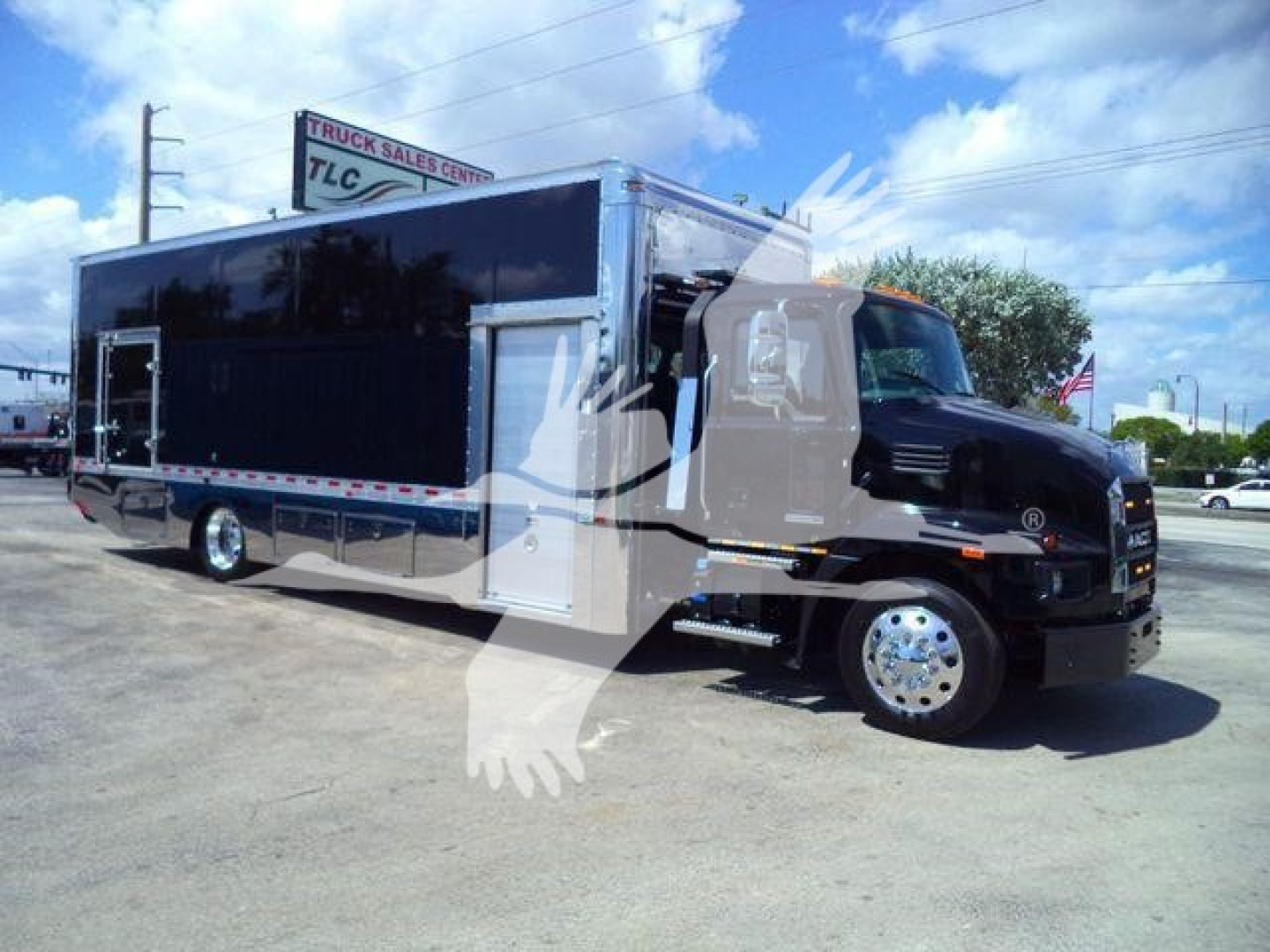 MD6 rollback truck with a dark blue housing and chrome wheels, front cab of a black Mack Md6 with a wide windshield. Large graphic watermark from the listing overlaps.