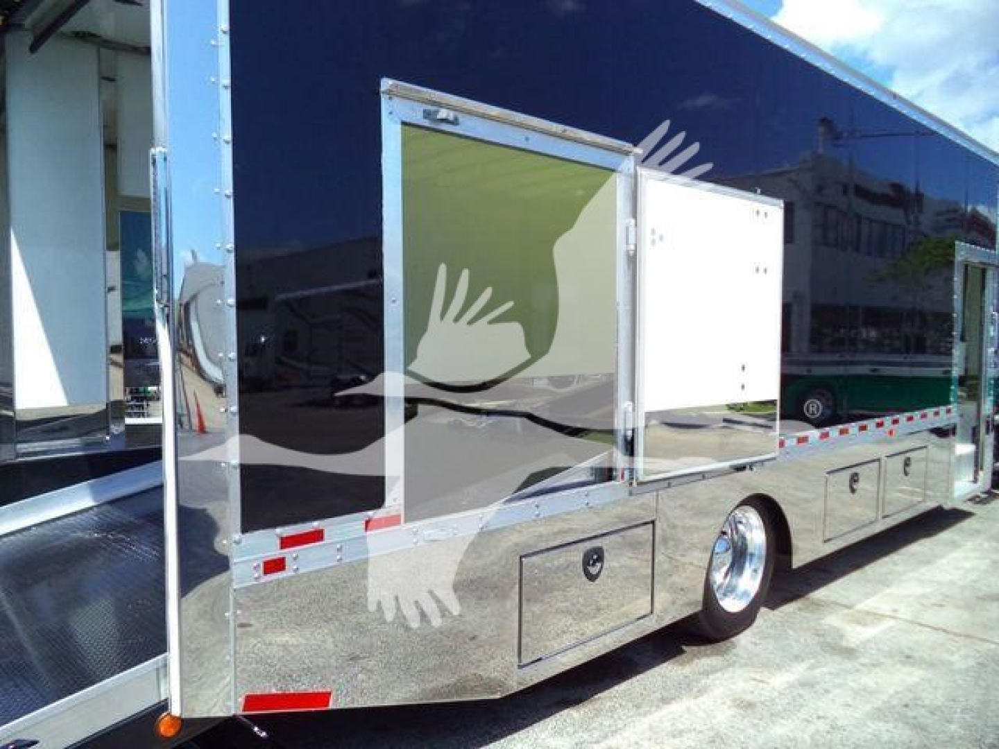 A blue Mack MD6 rollback truck with side compartments and chrome wheels; visible text includes stock and category labels in listing details.