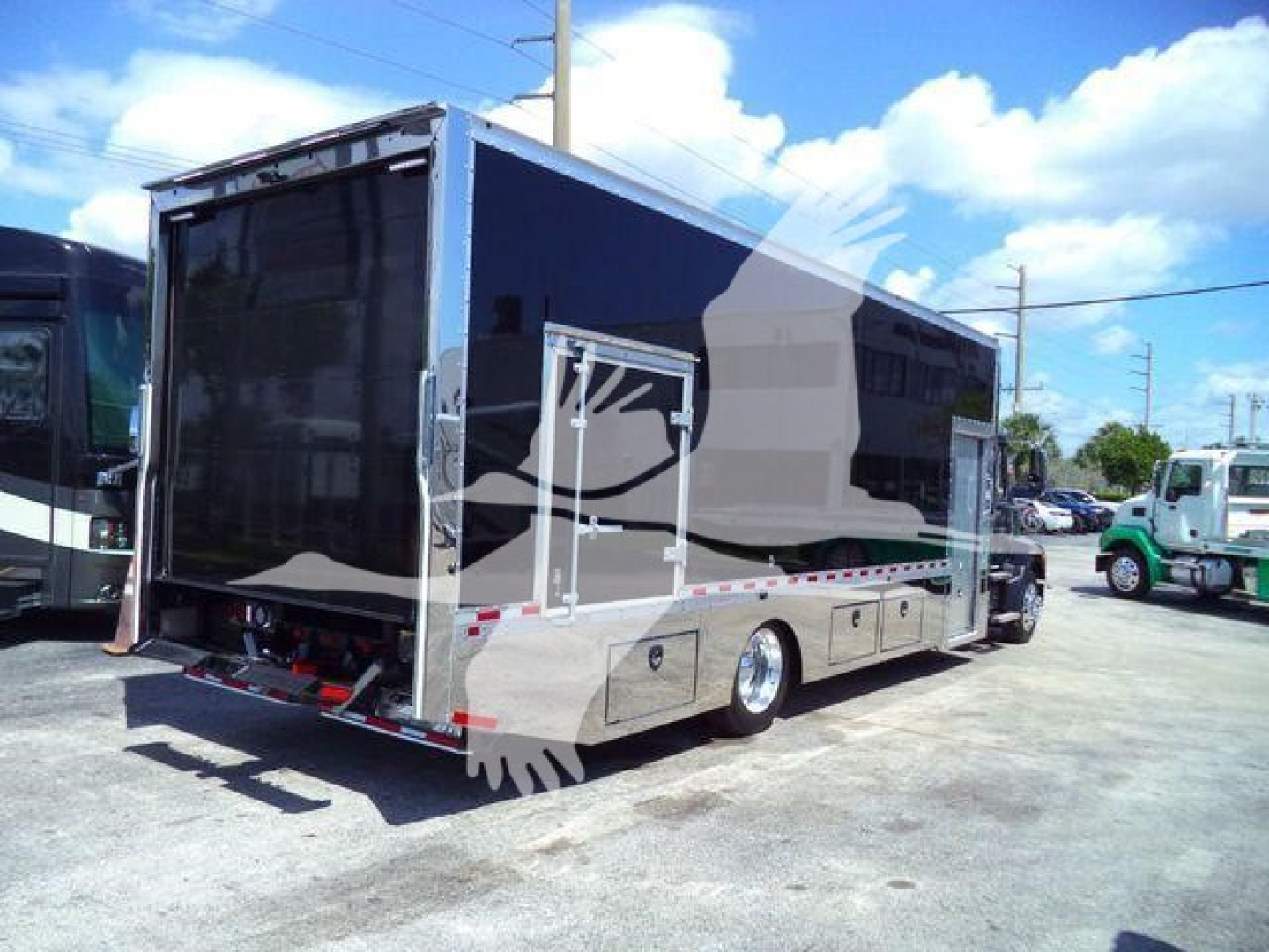 MD6 rollback truck body showing black cargo box and rear liftgate with reflective strips.