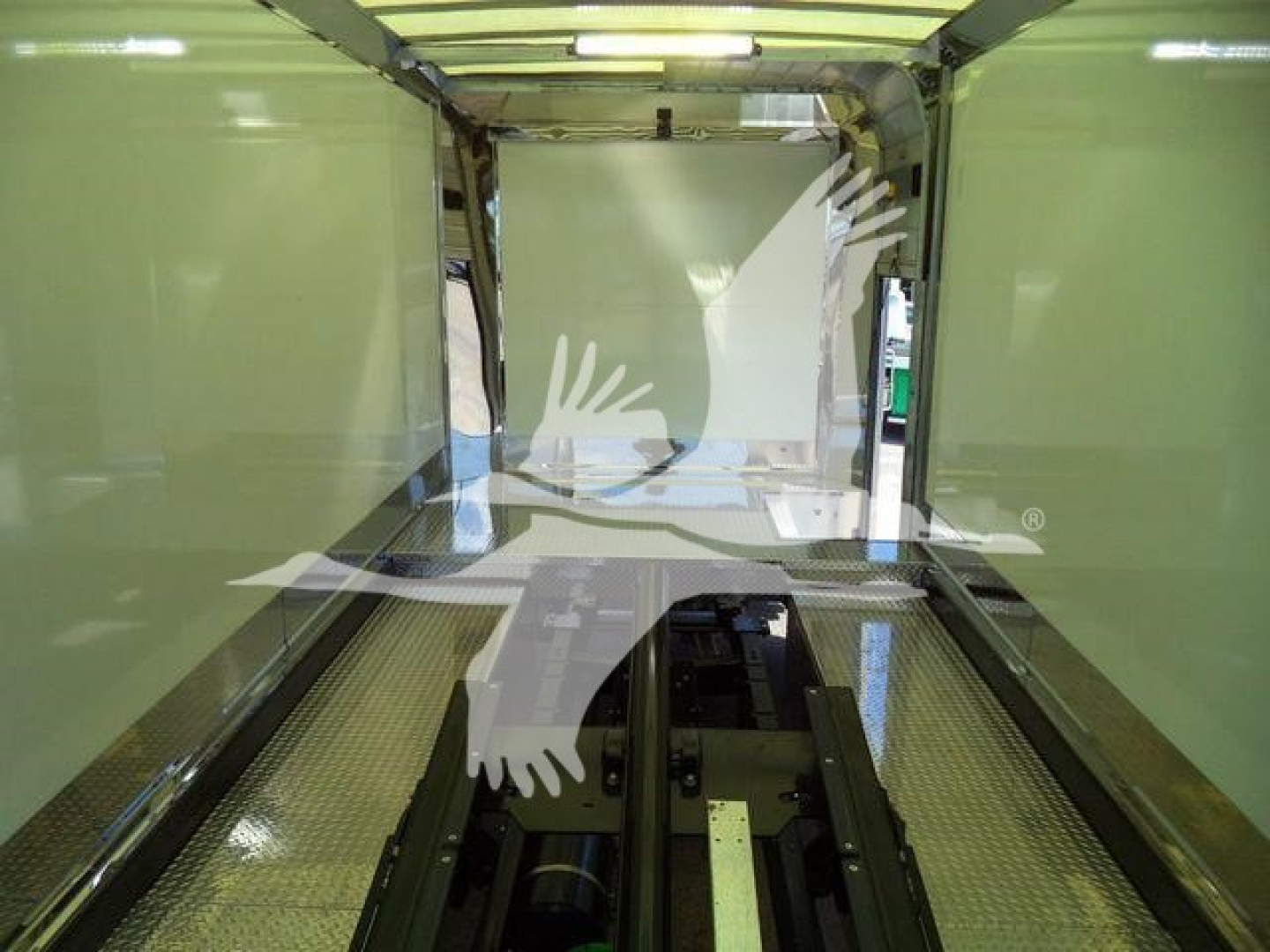 Mack MD6 rollback truck interior showing empty cargo area with side walls and floor.