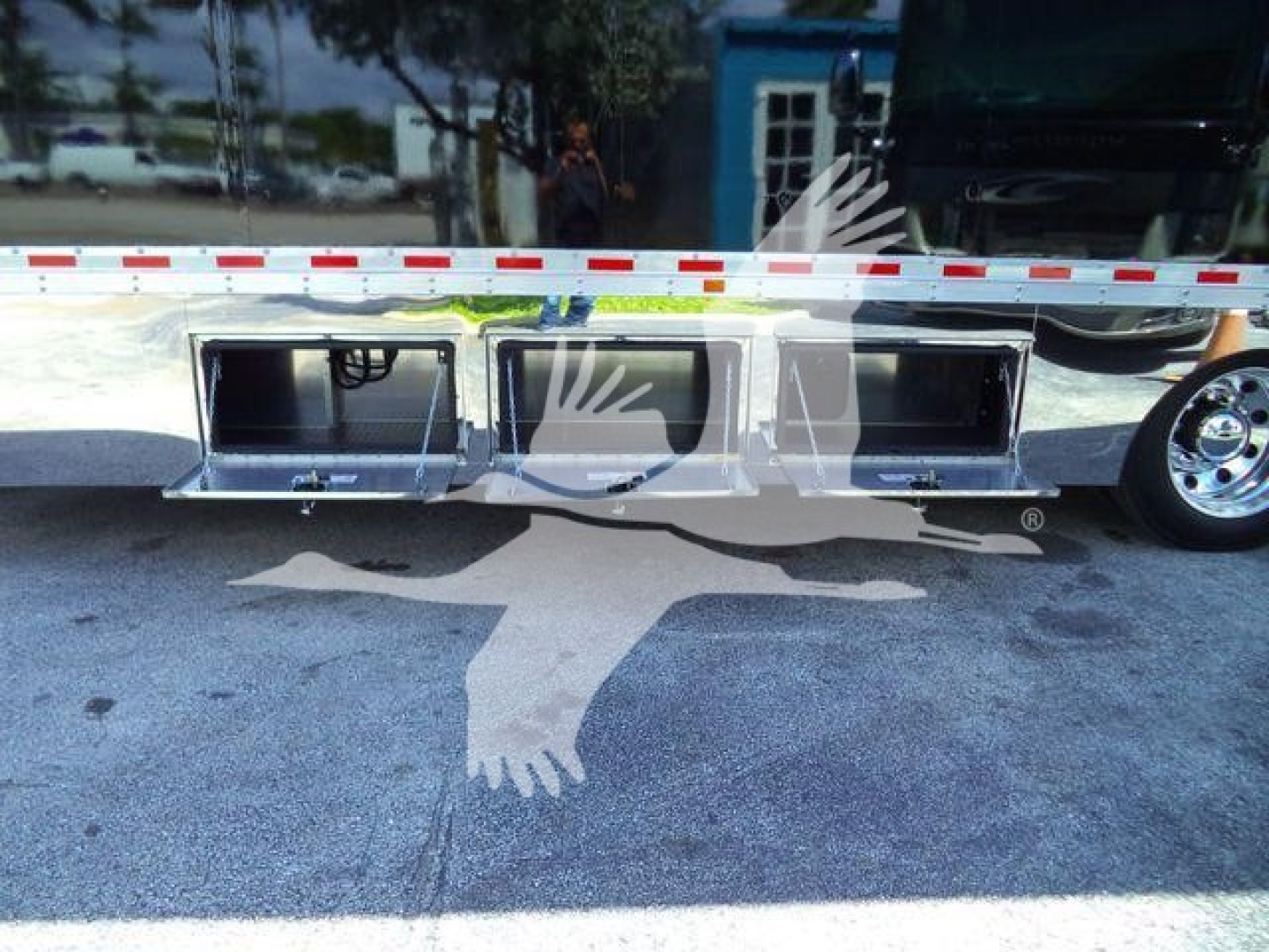 Truck side showing underbody storage compartments on Mack MD6 rollback bed with multiple aluminum drawers.