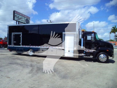 MD6 rollback truck body showing large black cargo area with a white side door and wheel well, stock number 26FTMD6TOWBOX
