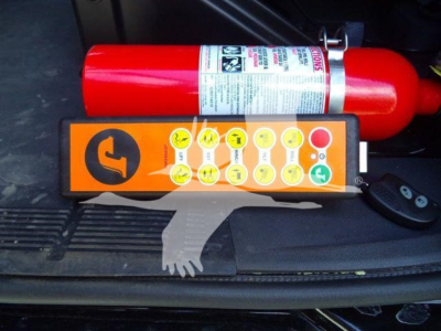 MD6 truck rollback equipment showing orange control panel with circular icons and a red fire extinguisher mounted in the cargo area.