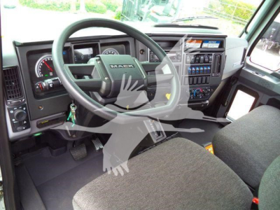 Dashboard and steering wheel view of a Mack MD6 truck cab with instrument cluster and control panel visible.