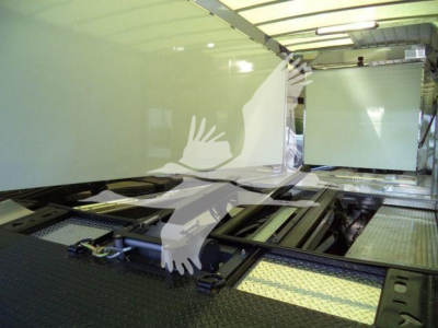 Mack MD6 rollback tow truck interior showing empty platform bed area with hydraulic rails and side panels.