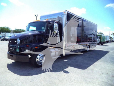 MD6 Mack rollback truck with a large black cab and a long aluminum cargo box, stock number 26FTMD6TOWBOX, new unit in a lot.