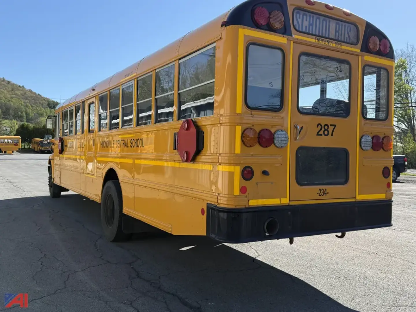 Yellow IC Corporation CE Series school bus rear view showing school bus number 287 and rear lights.