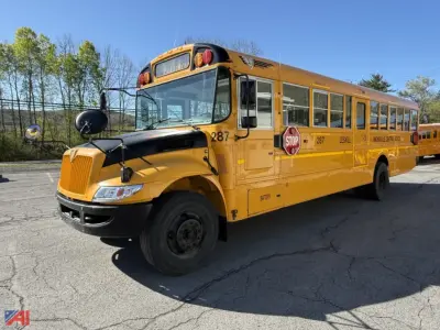 School bus 2018 IC Corporation CE Series, yellow, front-left view, with stop sign extended and door open on the passenger side; bus number 287 visible near front; black bumper and mirrors.