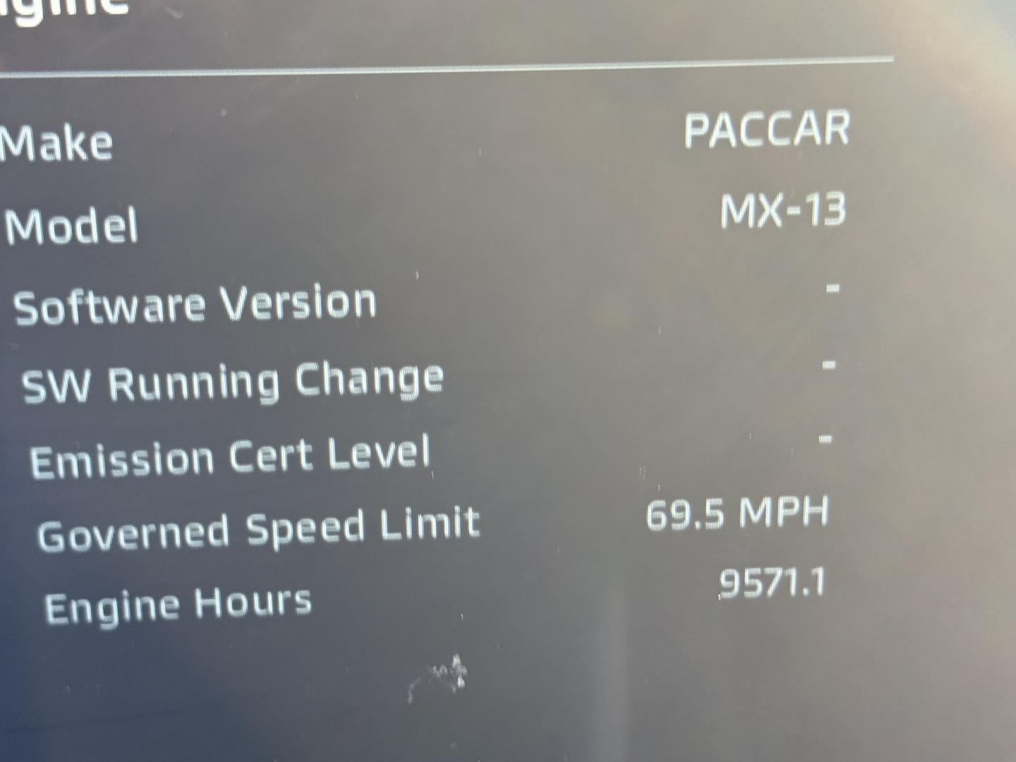 Vehicle instrument cluster screen showing engine data: Make PACCAR, Model MX-13, Governed Speed Limit 69.5 MPH, Engine Hours 9571.1, no software version or SW changes listed.